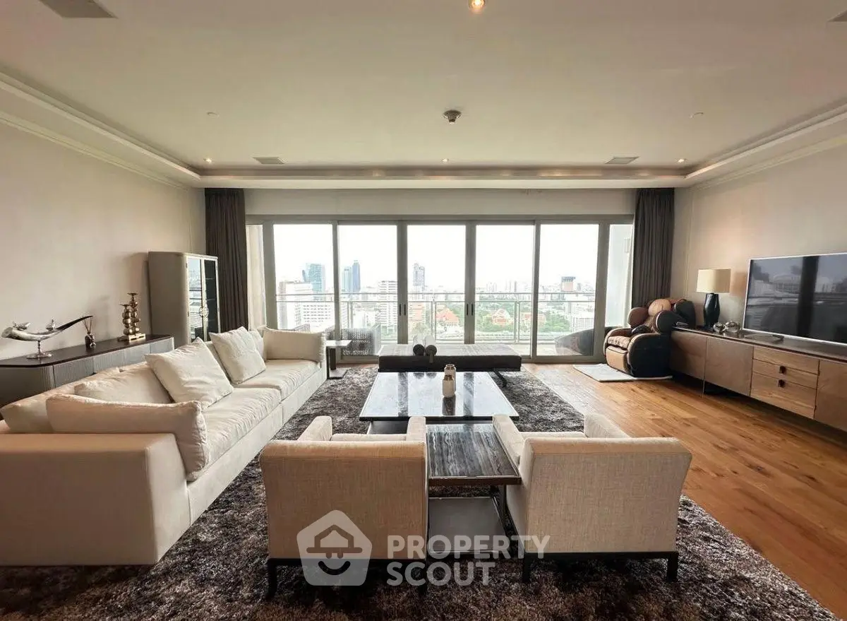 Spacious luxury living room with panoramic city view and elegant furnishings.