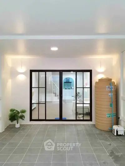 Modern interior space with sliding glass doors and water tank, ideal for versatile use.