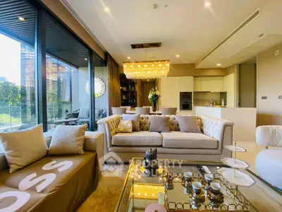 Luxurious living room with elegant decor and stunning city view, featuring plush sofas and a modern open kitchen.
