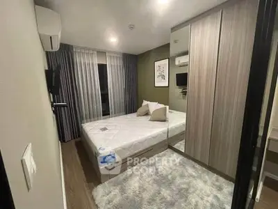 Modern bedroom with stylish decor, mirrored wardrobe, and cozy ambiance in a contemporary apartment.