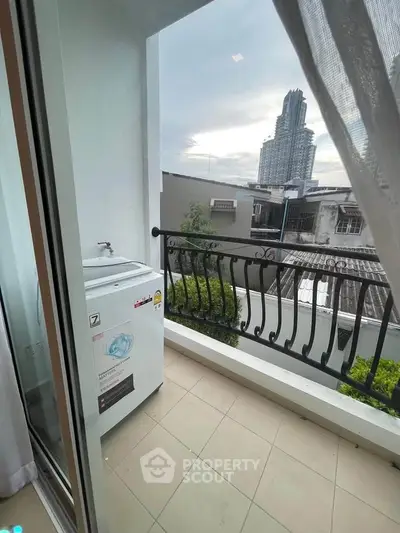 Charming balcony with city view and washing machine, perfect for urban living.