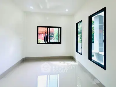 Bright and airy room with large windows and glossy tiled floor, perfect for customization.