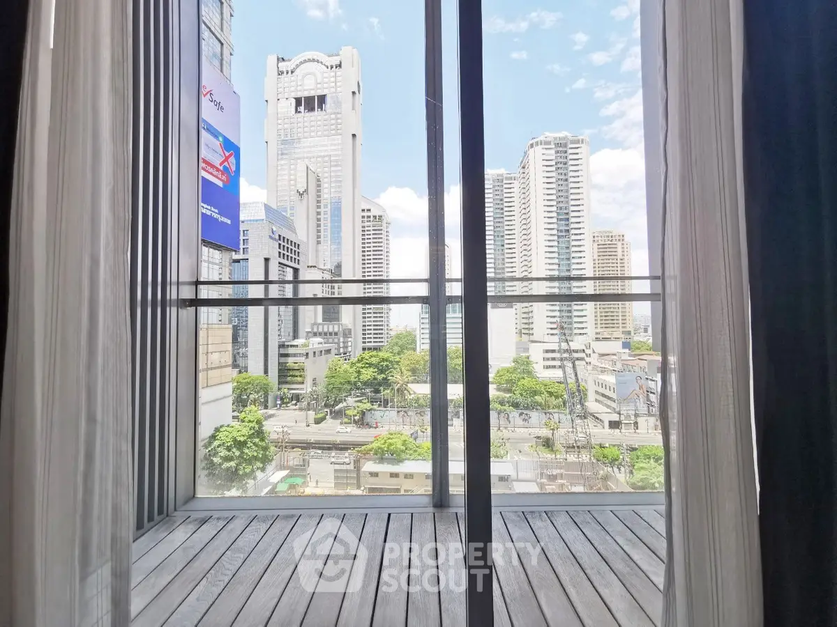 Stunning cityscape view from a modern balcony with floor-to-ceiling windows.