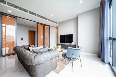 Luxurious modern living room with elegant furniture and large windows offering city views.