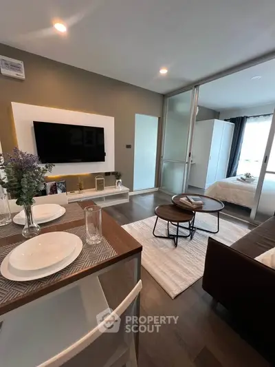 Modern open-plan living room with stylish decor and cozy bedroom view