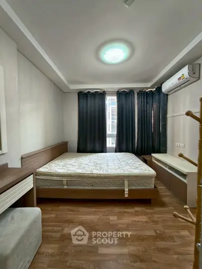 Cozy bedroom with modern furnishings and natural light