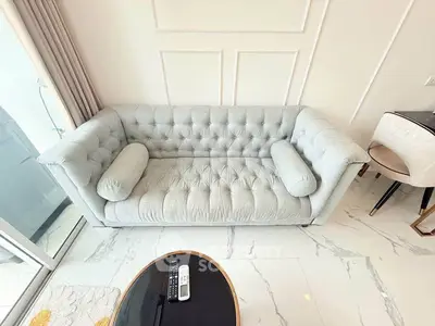 Luxurious modern living room with elegant tufted sofa and marble flooring