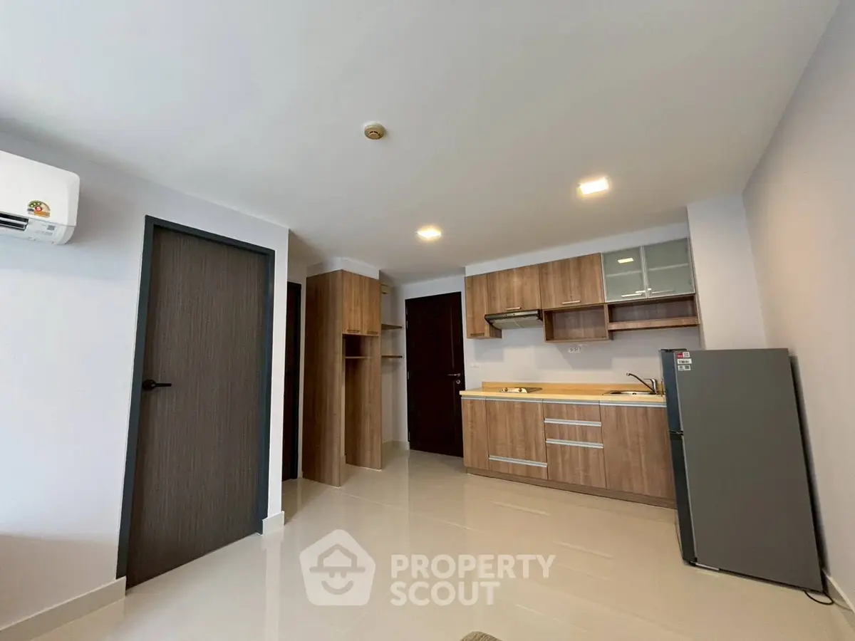 Modern kitchen with sleek cabinetry and appliances in a stylish apartment interior.