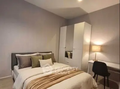 Cozy bedroom with modern decor, featuring a comfortable bed, stylish wardrobe, and a functional study desk.