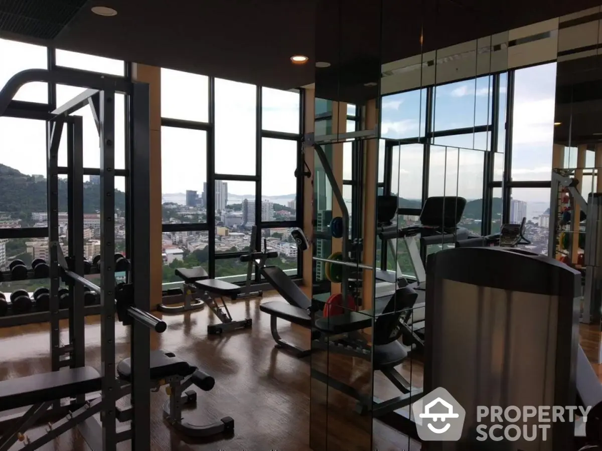 Luxury gym with panoramic city views and modern fitness equipment