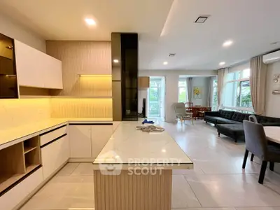Spacious open-plan kitchen and living area with modern design and ample natural light.