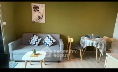 Cozy living room with modern sofa and dining area, perfect for small apartments.
