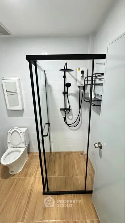 Modern bathroom with glass shower enclosure and sleek fixtures