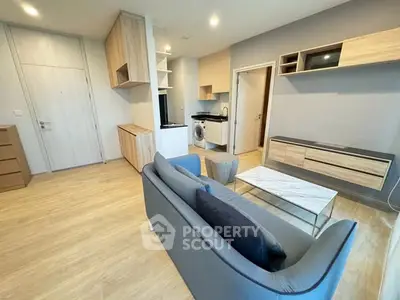 Modern living room with sleek furniture and integrated kitchen appliances