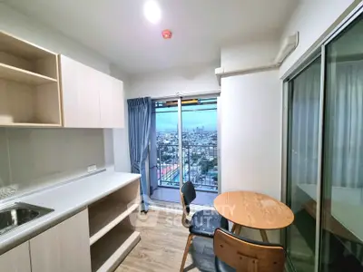 Modern kitchen with city view, featuring sleek cabinetry and cozy dining area.