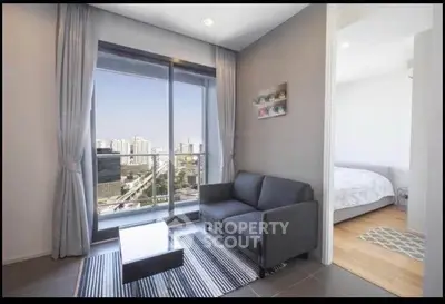 Modern living room with city view, featuring a cozy sofa and stylish decor.