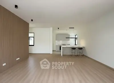 Spacious modern living room with open kitchen and stylish wooden flooring