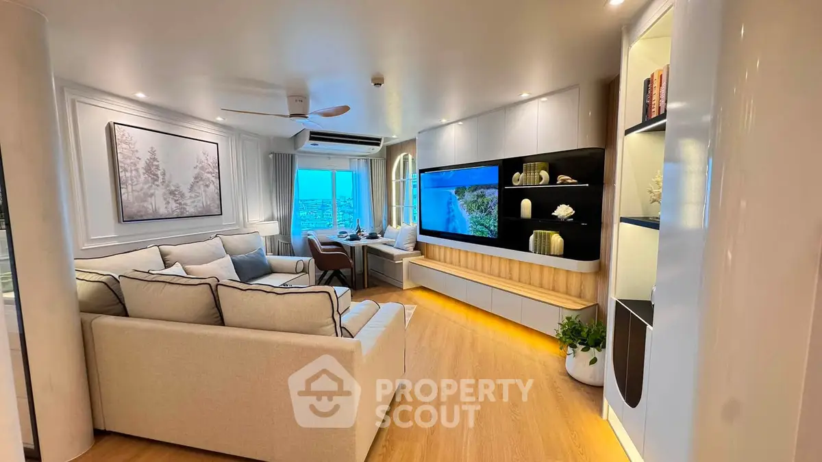 Luxurious modern living room with panoramic city view, elegant decor, and cozy seating area.