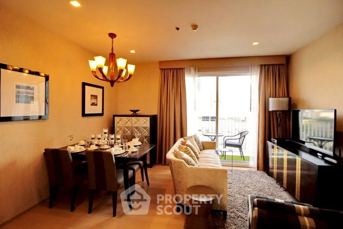 Elegant living room with dining area and balcony access, featuring modern decor and ample natural light.