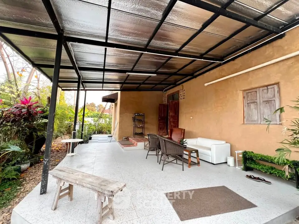 Charming outdoor patio with seating area and lush greenery, perfect for relaxation and entertaining.