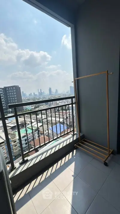 Stunning city view from a modern balcony with sleek railing and ample sunlight.
