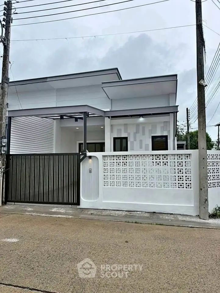 Modern single-story house with sleek design and gated entrance, perfect for contemporary living.