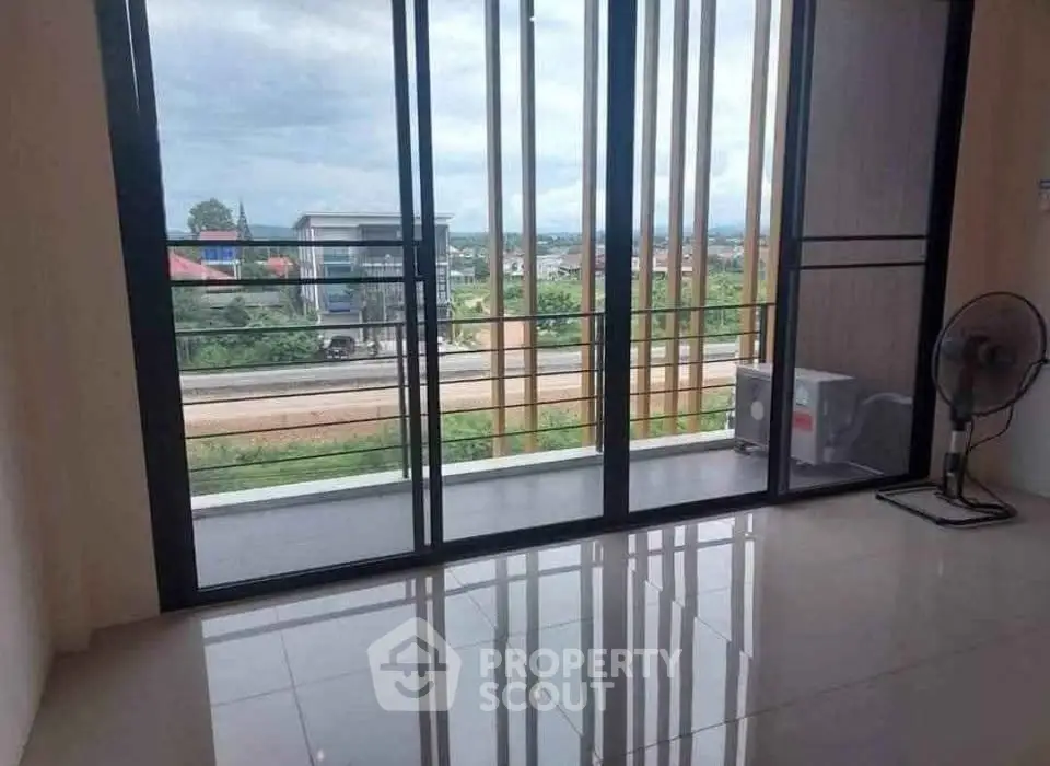 Spacious room with large windows offering a scenic view, perfect for natural light lovers.