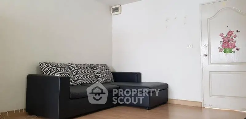 Cozy living room with black sectional sofa and minimalist decor