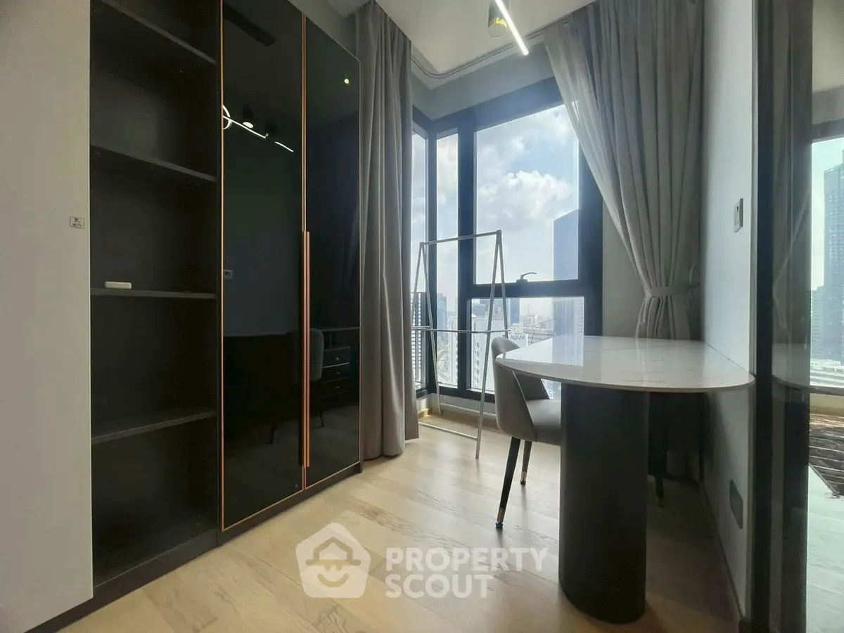 Modern study room with large windows and city view, featuring sleek furniture and ample natural light.