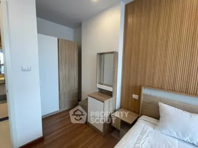 Modern bedroom with wooden accents and sleek design in a stylish apartment.