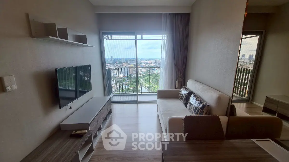 Modern living room with balcony and stunning city view in high-rise apartment