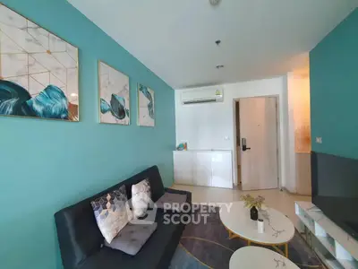 Modern living room with teal accent wall and stylish decor
