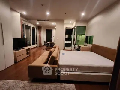 Spacious modern bedroom with stylish furniture and open layout in luxury apartment.