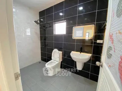Modern bathroom with sleek black tiles and contemporary fixtures