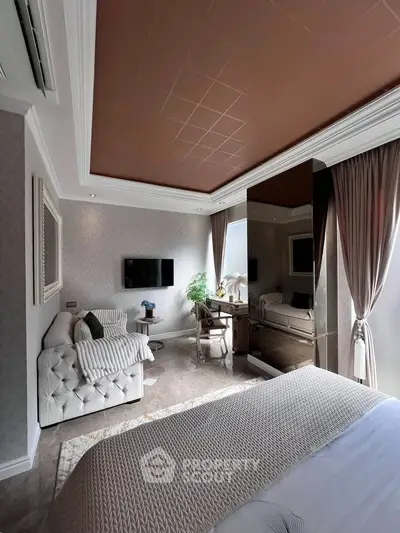 Luxurious bedroom with elegant decor, featuring a cozy seating area and large windows for natural light.