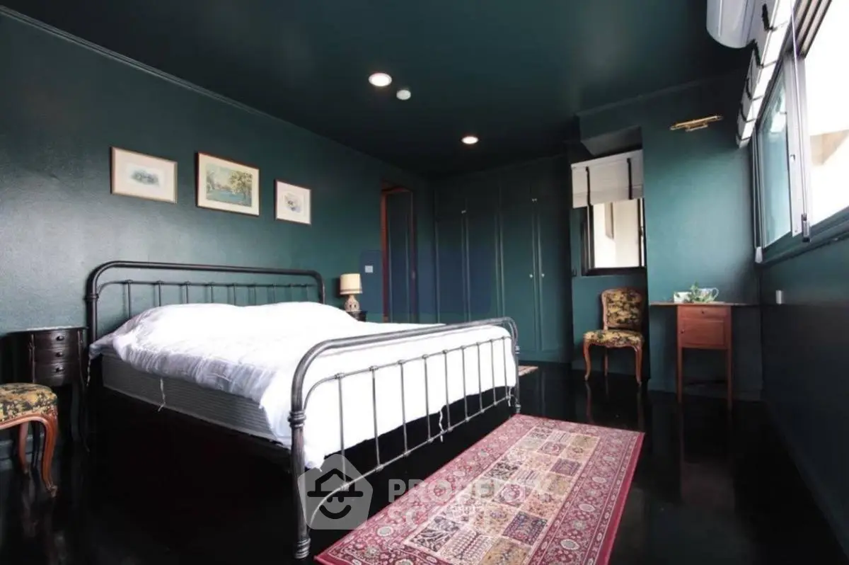 Charming bedroom with dark walls, vintage decor, and natural light