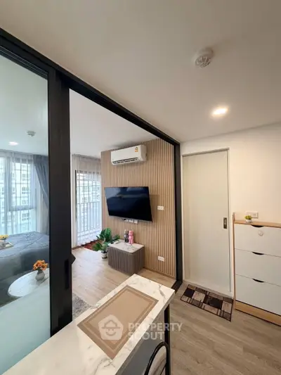 Modern apartment interior with open layout, featuring a cozy living area and stylish decor.