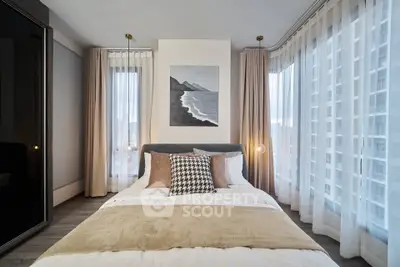 Modern bedroom with floor-to-ceiling windows and stylish decor in urban apartment.