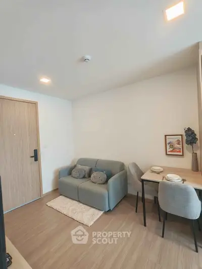 Cozy living room with modern decor and dining area in a stylish apartment.