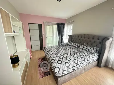 Spacious bedroom with modern decor and large bed in a stylish apartment.