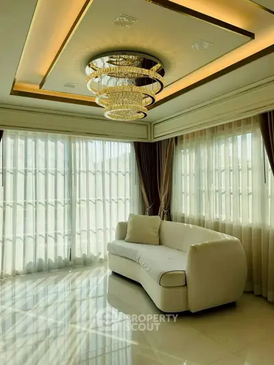 Luxurious living room with elegant chandelier and large windows