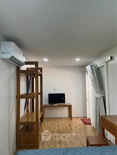 Modern bedroom with wooden furniture and air conditioning