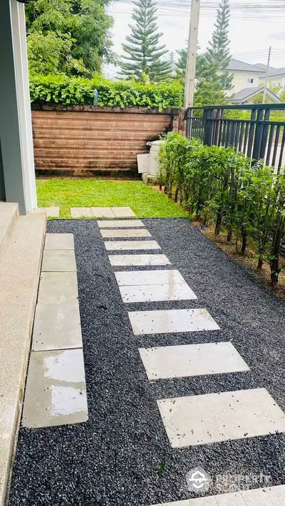 Charming garden pathway with modern stepping stones and lush greenery