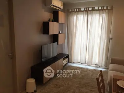 Cozy living room with modern TV unit and natural light