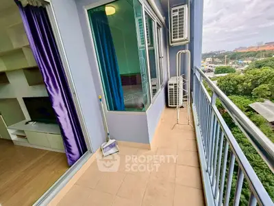 Spacious balcony with city view and modern interior access, perfect for relaxation.