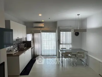 Modern kitchen and dining area with sleek design and natural light