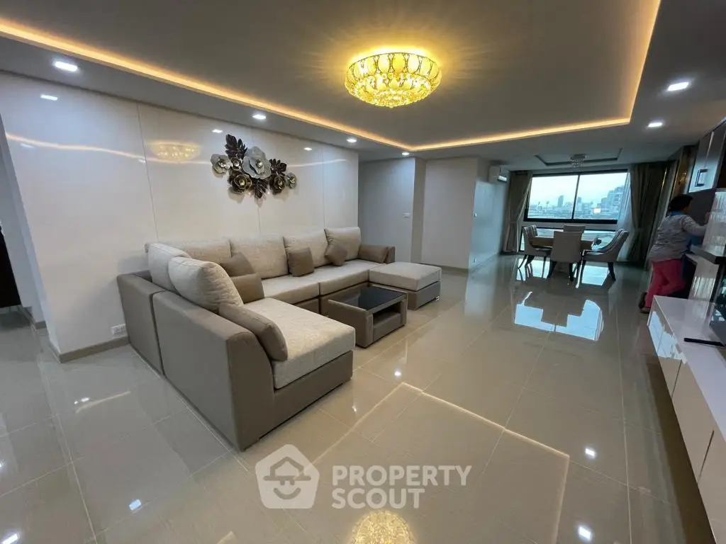 Spacious modern living room with elegant lighting and city view.