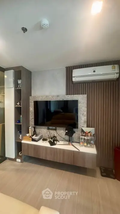 Modern living room with sleek TV setup and air conditioning
