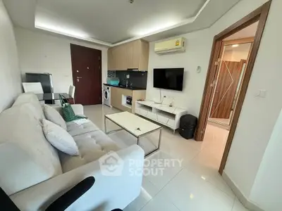 Modern living room with sleek furniture and integrated kitchen appliances