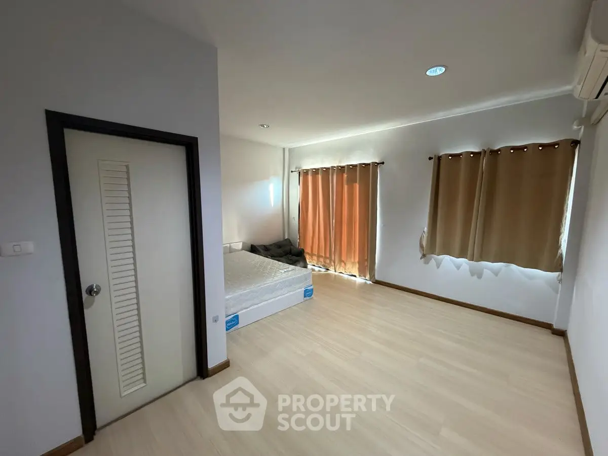 Spacious bedroom with natural light and minimalist design